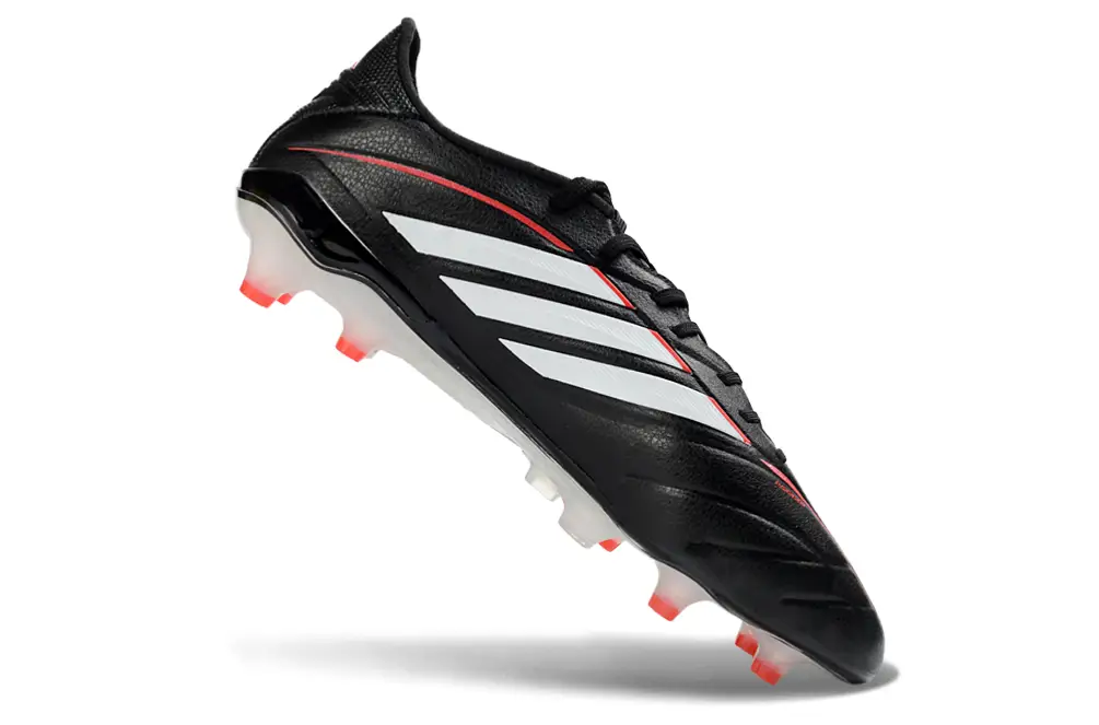 Adidas Copa Pure IV Elite FG football in action with player kicking the ball on a grass field